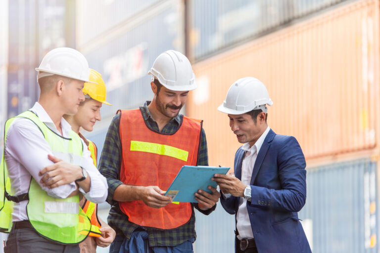 WCL group of container workers discuss work on a dock